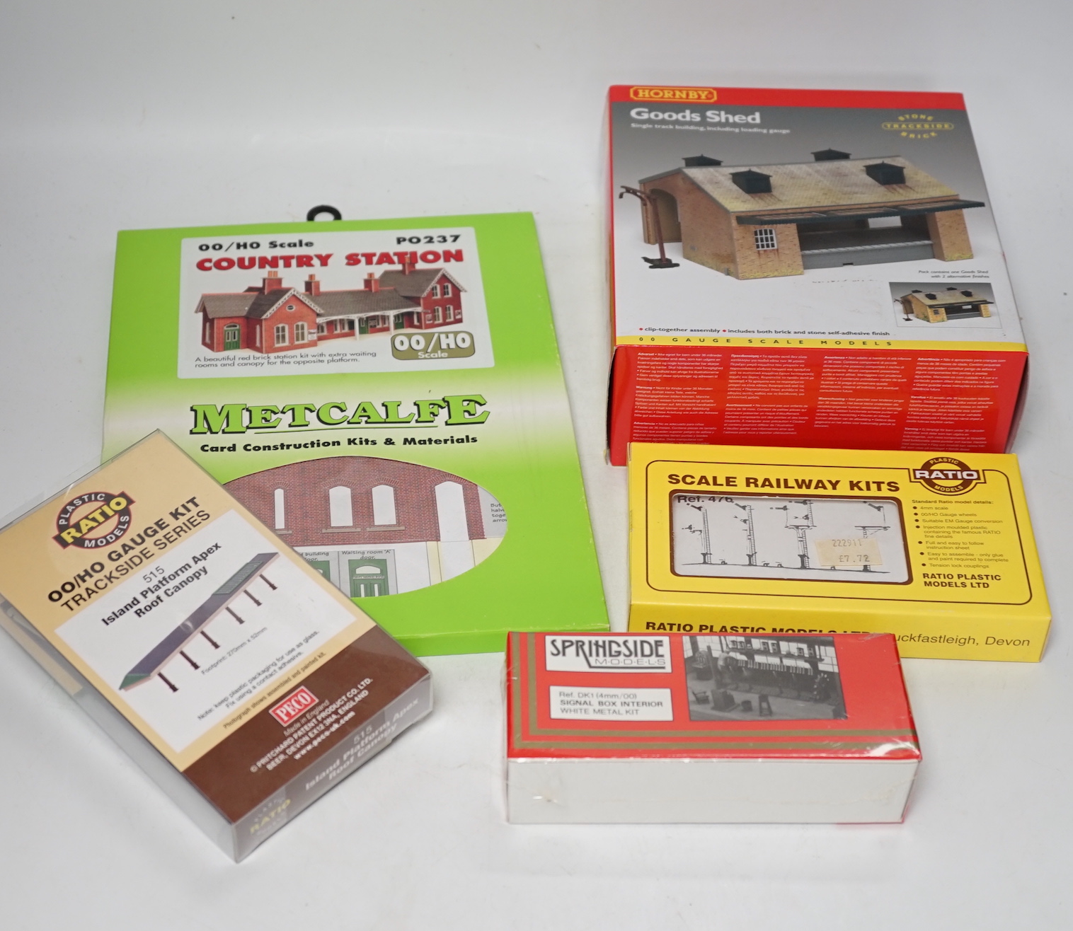 A collection of boxed and unconstructed 00 and HO Gauge model railway kits and trackside accessories, by Ratio, Metcalfe, Peco, Springside Models, etc. including; goods sheds, engine sheds, station buildings, signals, et